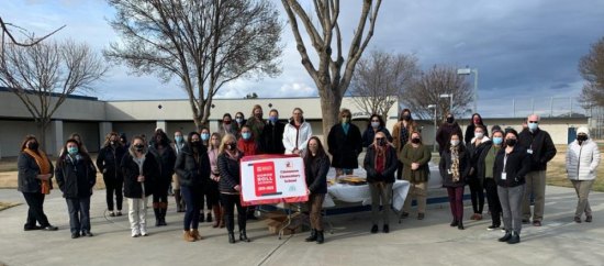 Lemoore's Cinnamon Elementary School staff show off their banner as a National Honor Roll School.
